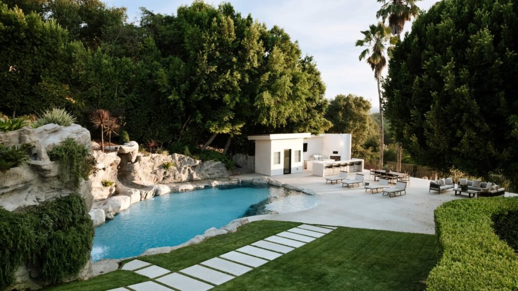 Mark Wahlberg’s former Beverly Hills estate is on the market for \$21.8M featuring seven bedrooms, luxury amenities, a grotto pool, guesthouse, gym and canyon views.